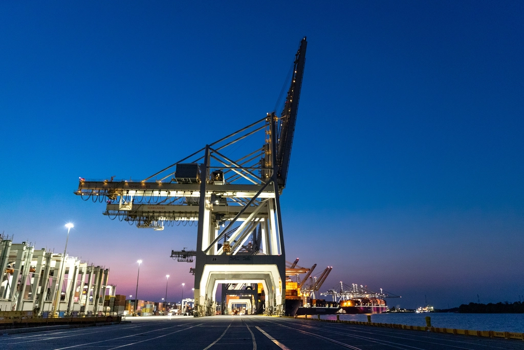Quay cranes over a container terminal at dusk