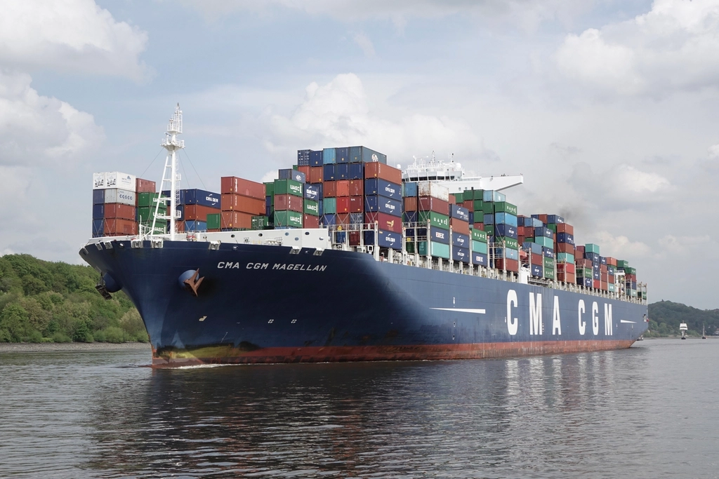 Container ship moving along a river